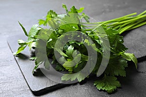 Bunch of fresh green parsley on grey table