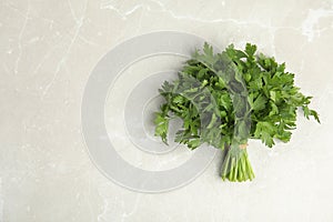 Bunch of fresh green parsley on light background, view from above.