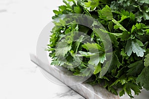 Bunch of fresh green parsley on marble table, closeup