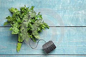 Bunch of fresh green parsley and rope on blue table, flat lay. Space for text