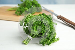 Bunch of fresh green parsley on table