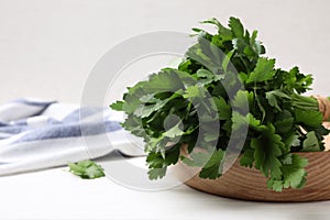 Bunch of fresh green parsley on white table, closeup. Space for text