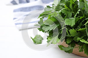 Bunch of fresh green parsley on white table, closeup. Space for text