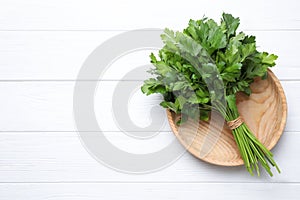 Bunch of fresh green parsley on white table, top view. Space for text