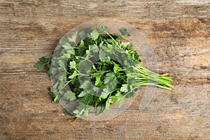 Bunch of fresh green parsley on wooden background