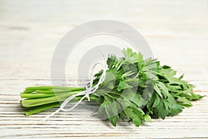 Bunch of fresh green parsley on wooden background.