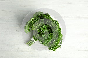 Bunch of fresh green parsley on wooden background