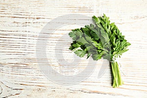 Bunch of fresh green parsley on wooden background, view from above