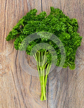 Bunch of fresh green parsley on wooden table