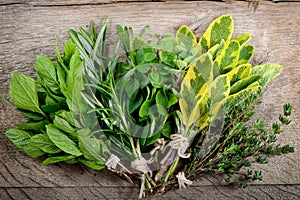 Bunch of fresh herbs wooden background.