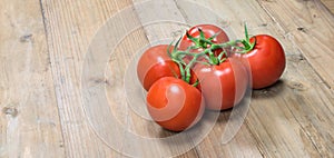 Bunch of fresh juicy tomatoes on wood.