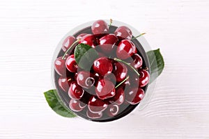 Bunch of fresh organic sweet cherries on textured background. Clean eating concept. Healthy nutritious vegan snack, raw diet.