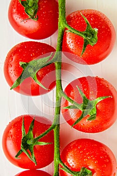 Bunch of fresh organic tomatoes on white background