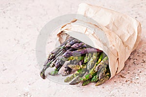 Bunch of fresh purple asparagus spears standing vertical