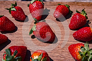 Bunch of fresh red strawberries drying on a wooden surface