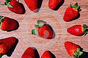 Bunch of fresh red strawberries drying on a wooden surface