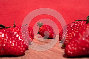 Bunch of fresh red strawberries drying on a wooden surface