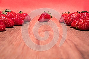 Bunch of fresh red strawberries drying on a wooden surface with copy space