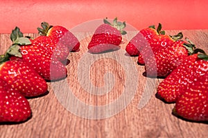 Bunch of fresh red strawberries drying on a wooden surface with copy space