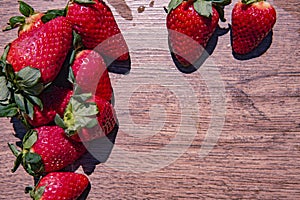 Bunch of fresh red strawberries drying on a wooden surface with copy space