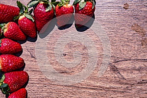 Bunch of fresh red strawberries drying on a wooden surface with copy space