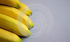Bunch of fresh ripe bananas on grey background