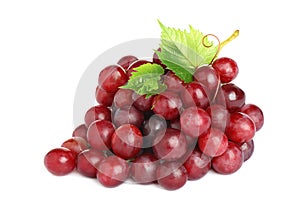 Bunch of fresh ripe juicy red grapes with leaves isolated on white