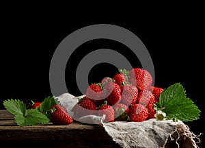 bunch of fresh ripe red strawberries on a gray linen napkin