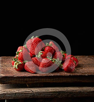 bunch of fresh ripe red strawberries on a  wooden table