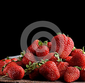 bunch of fresh ripe red strawberries on a  wooden table