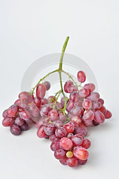 bunch of fresh seedless red grapes isolated on white background