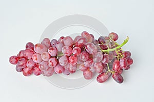 bunch of fresh seedless red grapes isolated on white background