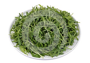 Bunch of fresh spring mustard leaves on a round plate