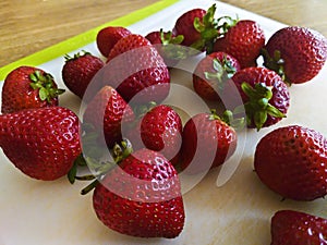 A bunch of fresh strawberries on a board