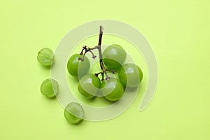 bunch of fresh sweet green shine muscat (vitis vinifera) grape and leaf isolate on green background