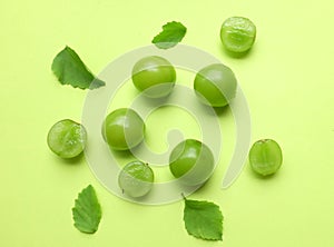 bunch of fresh sweet green shine muscat (vitis vinifera) grape and leaf isolate on green background