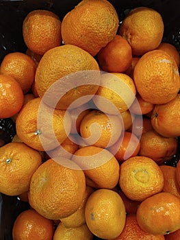 Bunch of fresh tangerines oranges on market