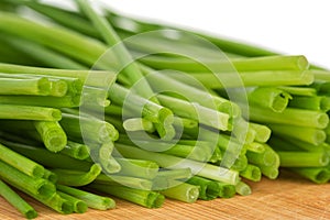 Bunch of freshly cut chives on a cutting board