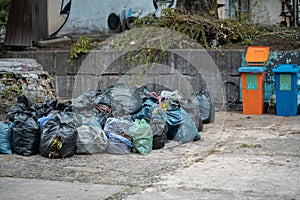 bunch of full plastic garbage bags after city clean up