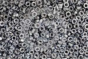 Bunch of galvanized hexagon nuts for bolts for fasten multiple parts together, hardware fasteners