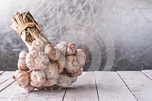Bunch of garlic on wooden table.