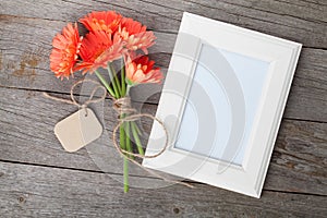 Bunch of gerbera flowers and photo frame