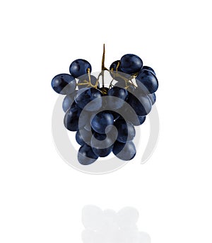 A bunch of grapes hanging in the air, isolated on a white background. Close up