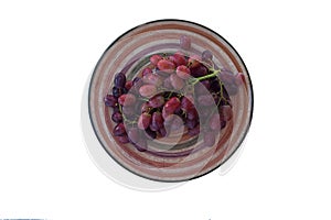 Bunch of grapes on a plate of isolate on a white background