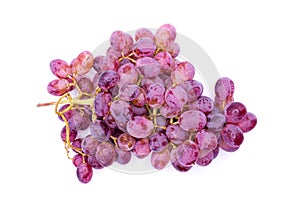 a bunch of grapes sitting on top of a white tablecloth covered table top next to a wine glass