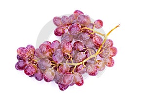 a bunch of grapes sitting on top of a white tablecloth covered table top next to a wine glass