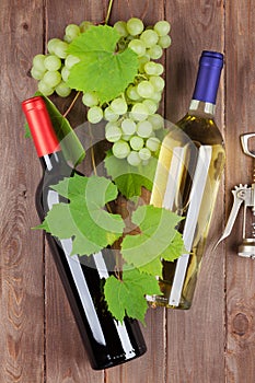 Bunch of grapes, wine bottles and corkscrew