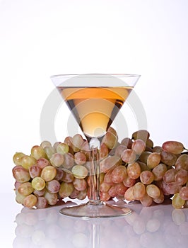 A bunch of grapes and wine in a glass
