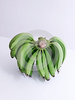 a bunch of green bananas sitting on top of each other