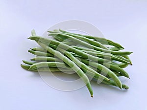 Bunch of green beans on white background.